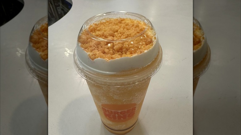 Burger King Orange Dreamsicle Freezee King in a clear cup with crunchy topping