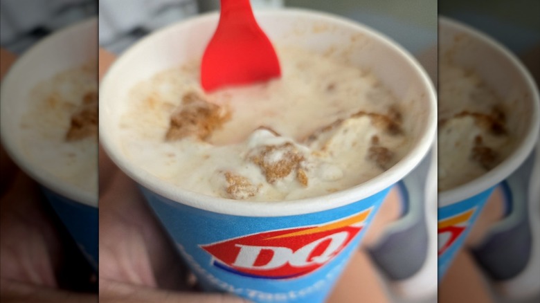 A Dairy Queen Biscoff Blizzard in a blue cup with the Dairy Queen logo