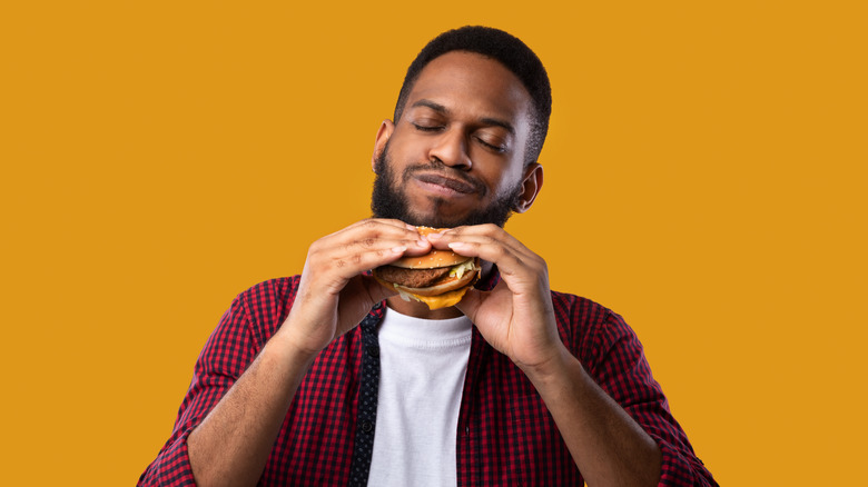 man enjoying a burger
