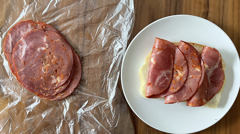 Hot Capicola on a plastic sheet and an open sandwich