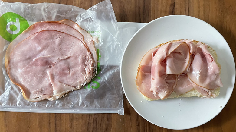 Tavern ham on a plastic sheet and an open sandwich