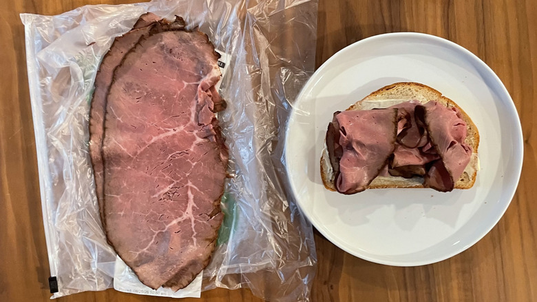 Roast beef on a plastic sheet and an open sandwich