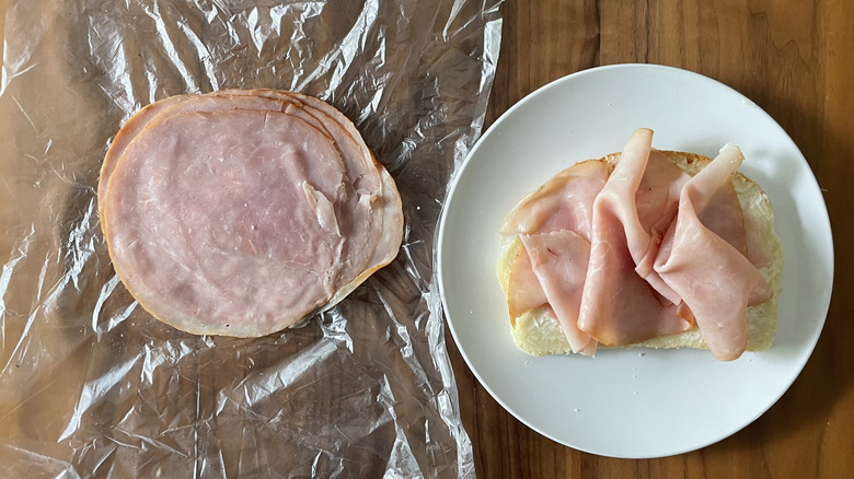 Hot honey ham on a plastic sheet and an open sandwich