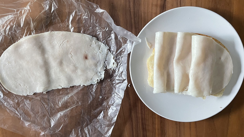 Turkey on a plastic sheet and an open sandwich