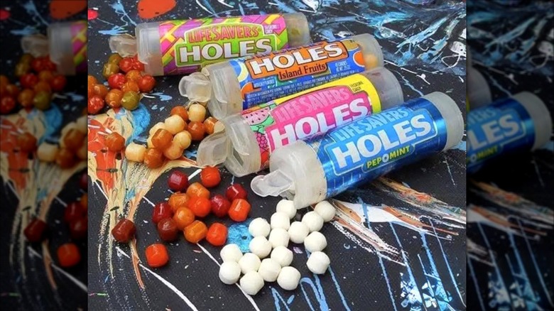 Opened containers of Life Savers holes with candies pouring out