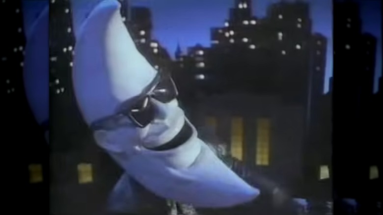 McDonald's moon-headed mascot Mac Tonight with a nightscape in the background
