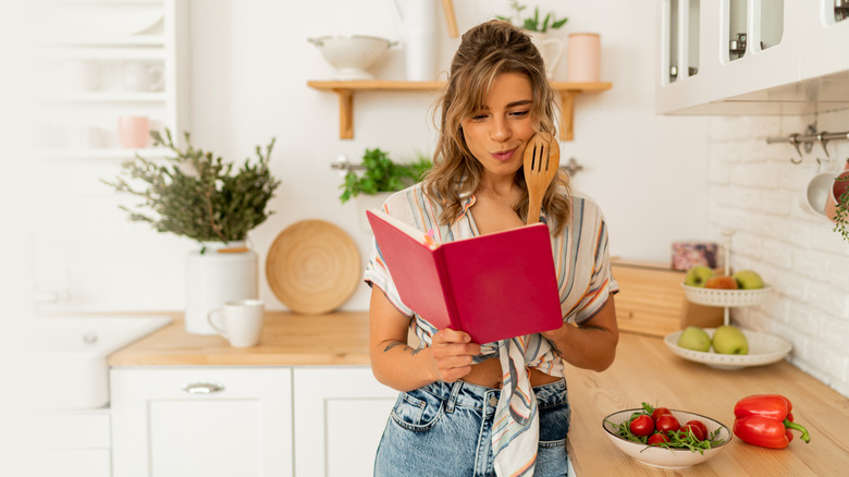 Woman reading a recipe before starting to cook