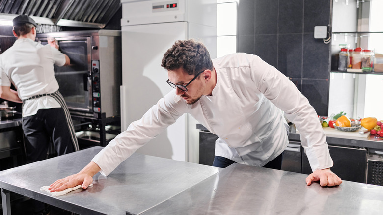 Chef cleaning a kitchen