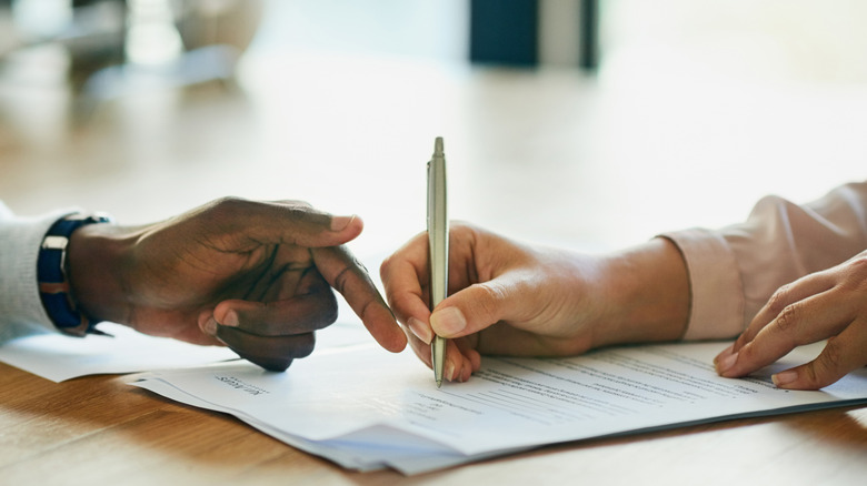 Two people looking over an official document