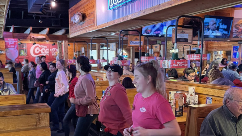 Texas roadhouse employees doing the line dance