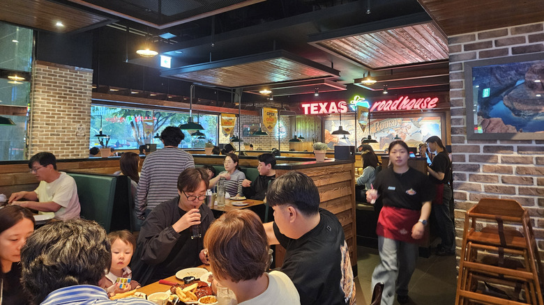 Texas Roadhouse employees serving food to tables