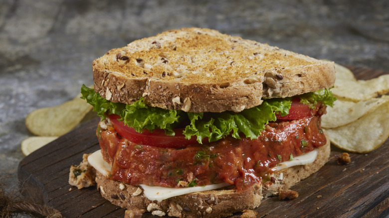 A meatloaf sandwich with lettuce and tomato
