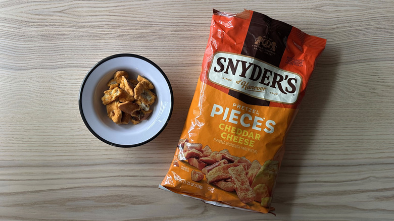 Snyder's Cheddar Cheese Pretzel Pieces on wooden table