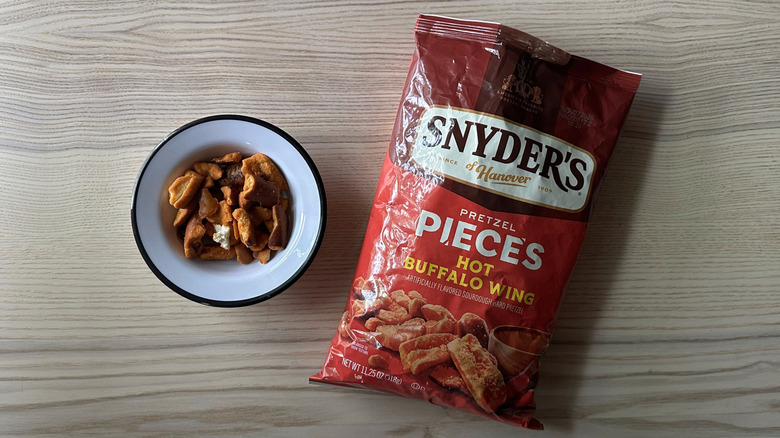 Snyder's Hot Buffalo Wing Pretzel Pieces on wooden table