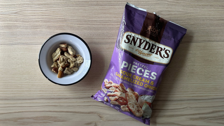 Snyder's Sour Cream and Caramelized Onion Pretzel Pieces on wooden table