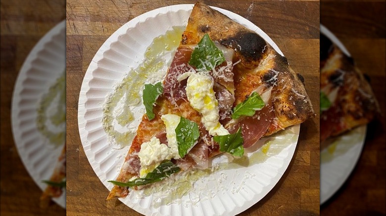 Slice of New York-style pizza on a paper plate