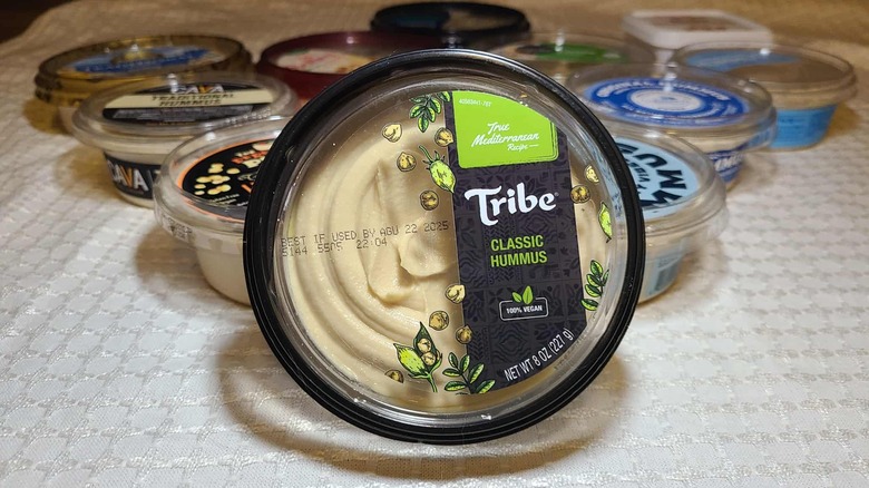 Various tubs of hummus with Tribe featured in the front