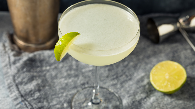 A coupe of daiquiri with a lime garnish