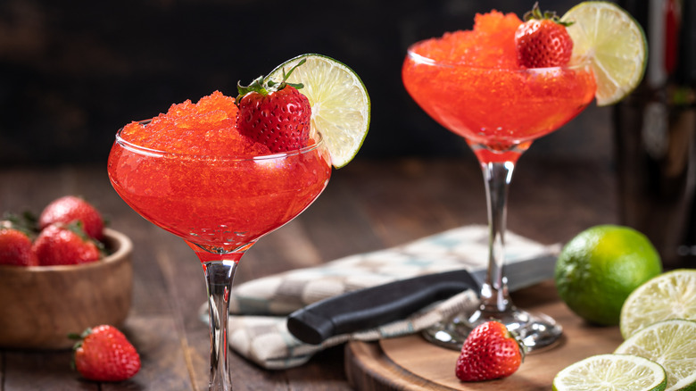 Two strawberry frozen daiquiris served with granishes
