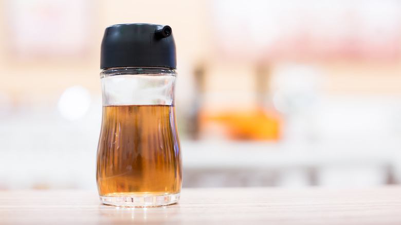 Small glass bottle of fish sauce on table