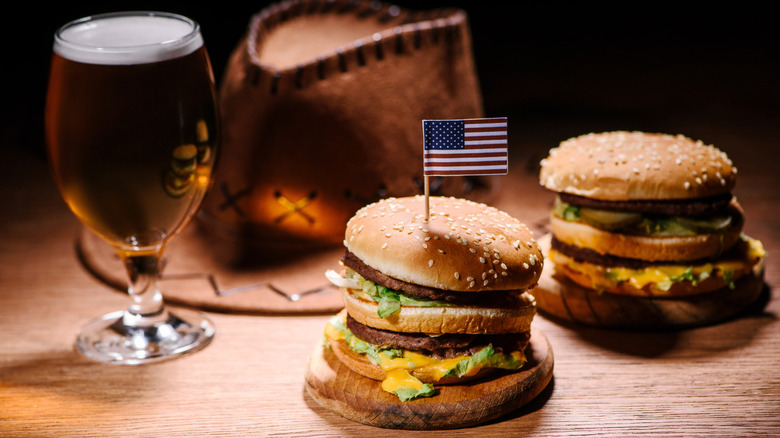 cheeseburgers with a beer and cowboy hat and american flag