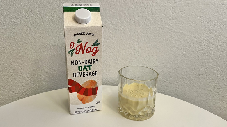 Non-dairy oat beverage from Trader Joe's in a carton and poured into a glass
