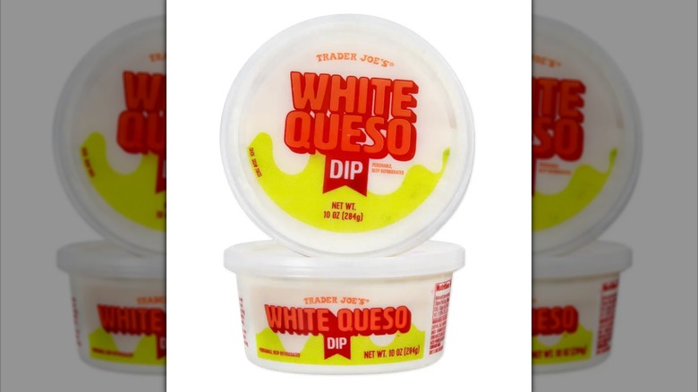 Two white tubs of Trader Joe's White Queso Dip