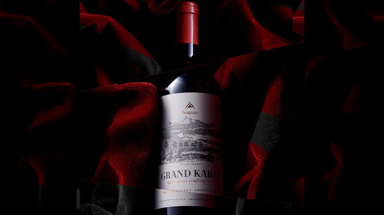 Bottle of Karas Grand Karas wine set in red cloth