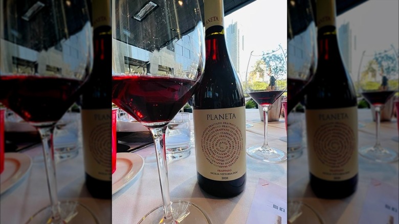 Planeta Frappato bottle and glass of red wine