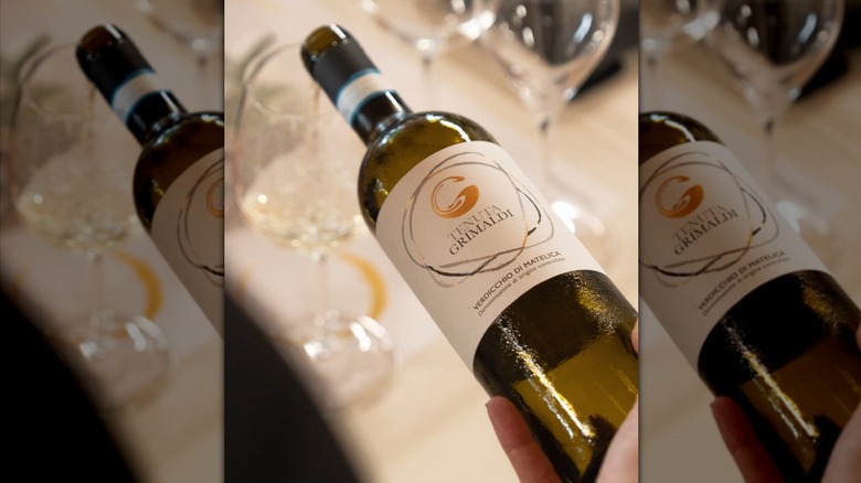 pouring white wine from bottle