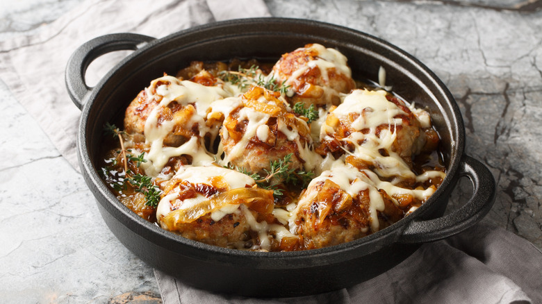French onion soup meatballs in black bowl with handles