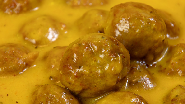 Meatballs cooked in yellow curry sauce