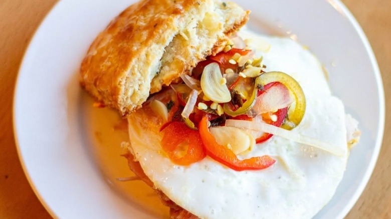 A biscuit sammie with the top pulled back to show the ingredients