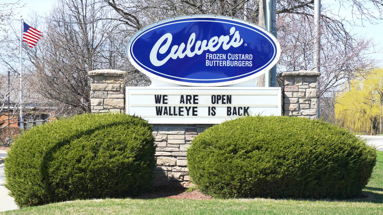 old-fashioned restaurant sign with advertisement and flag