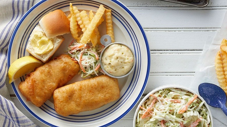 Plated fried fish with french fries and cole slaw