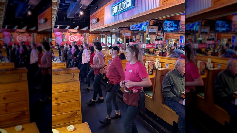 Texas Roadhouse line dancing in the middle of a restaurant aisle