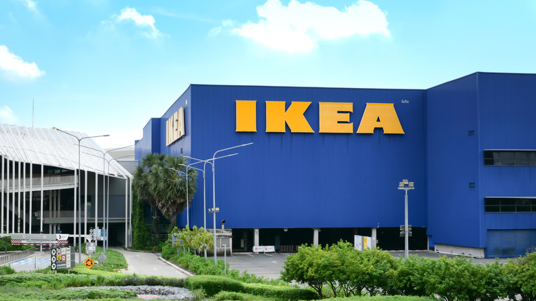 An Ikea building, blue with a yellow sign on it.