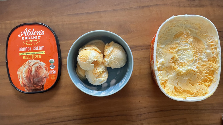 Orange ice cream in a bowl and in a container
