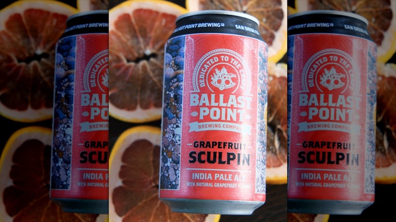 Can of Ballast Point Grapefruit Sculpin against blurred citrus background