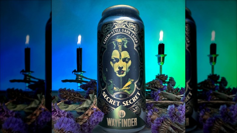 Can of Secret Secret with candles and dried flowers