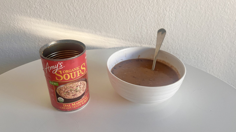 Dal makhani soup in a white bowl with a spoon