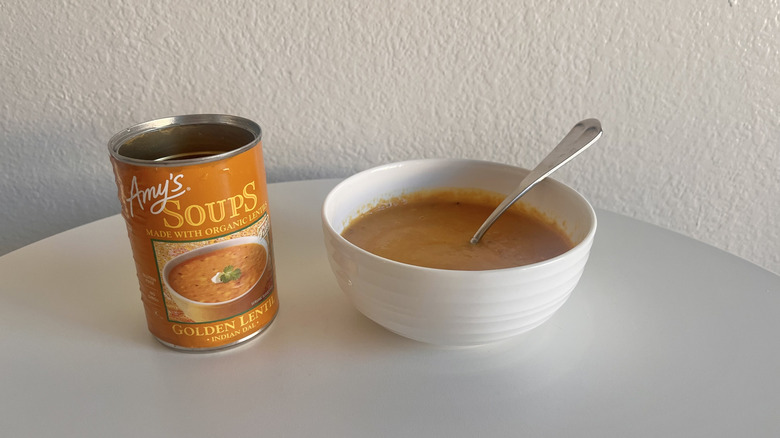 Golden lentil soup in a bowl on a table