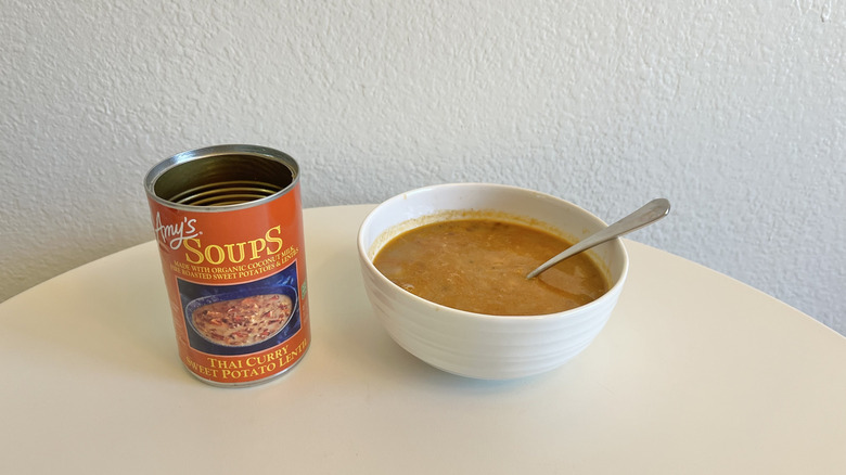Thai sweet potato soup in a white bowl with a spoon