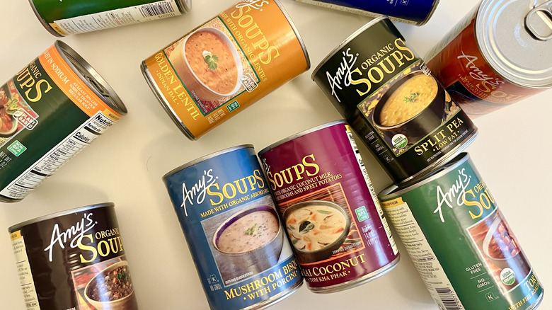 Various Amy's canned soups on table