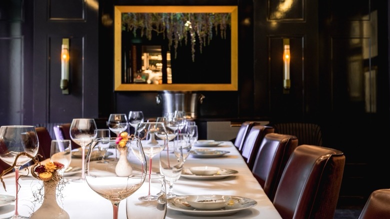 Elegantly set table and mirror on the wall inside the Atlas restaurant in Atlanta