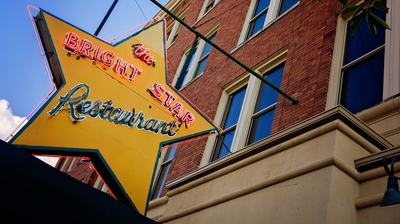 The Bright Star's yellow sign in Bessemer, Alabama during the daytime