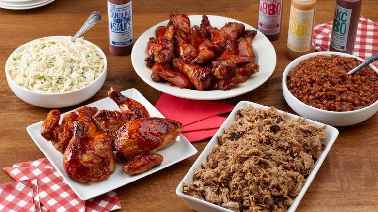 table full of barbecue meats and sides