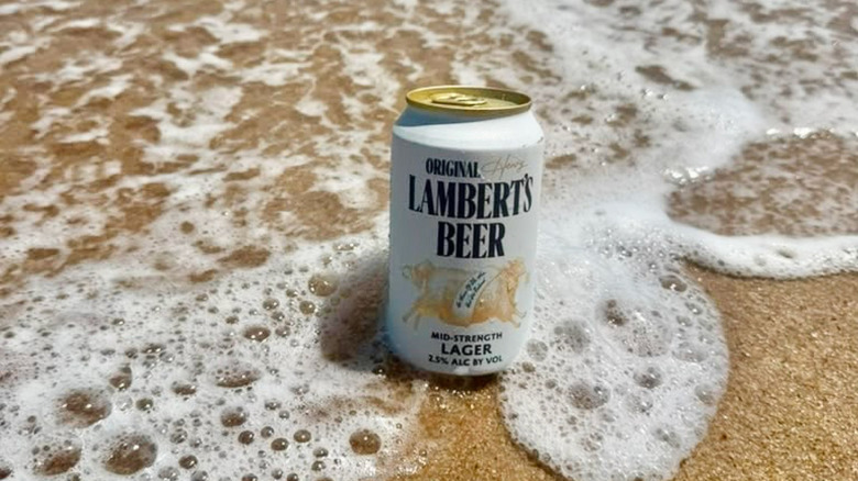 Can of Henry Lambert's in the ocean