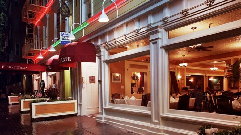 Exterior of Fior d'Italia at night with dining room through windows