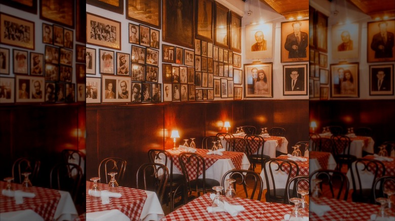interior dining room of Victor's Cafe with framed photos and red and white checked tablecloths